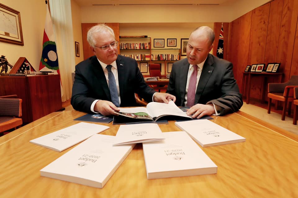Scott Morrison and Josh Frydenberg looking at budget papers